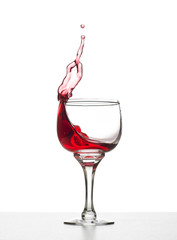 Glass with red wine splash