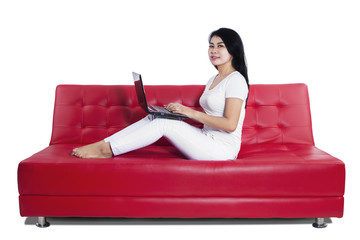 Casual young woman using laptop isolated