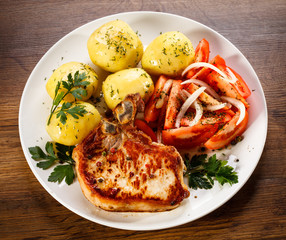 Grilled steak, boiled potatoes and vegetable salad