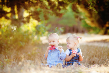 cute boy and girl playing together summer outdoors