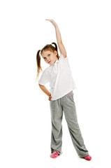 Little girl doing gymnastics in studio.
