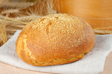 Freshly baked traditional bread on wooden table