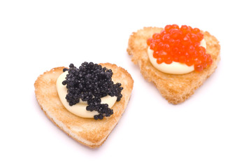 Two Heart-Shaped Toasts with Red and Black Caviar on White Sauce