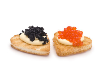 Two Heart-Shaped Toasts with Red and Black Caviar on White Sauce