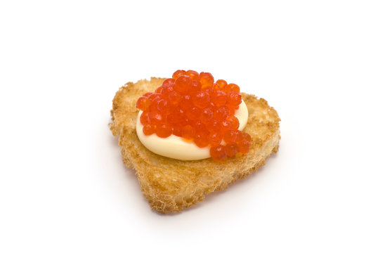 Heart-Shaped Toast with Red Caviar on White Sauce isolated on wh