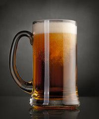 Mug of beer over black background