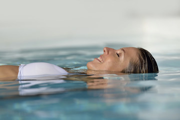 Woman relaxing in swimming pool