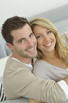 Upper view of sweet couple embracing in sofa