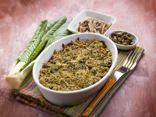 gratin of swiss chard anchovies and capers, selective focus