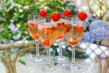 Summer cocktail with champagne, peppermint and fresh strawberrie