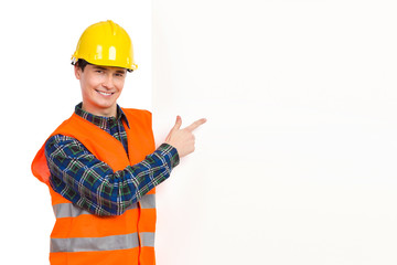 Construction worker pointing at banner.