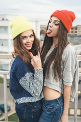 Two young  hipster girl friends