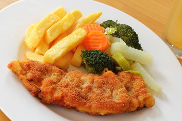 breaded escalope with fries and vegetables