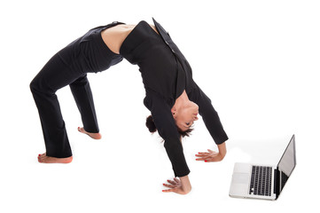 Suited Woman In Yoga Pose working with Laptop.