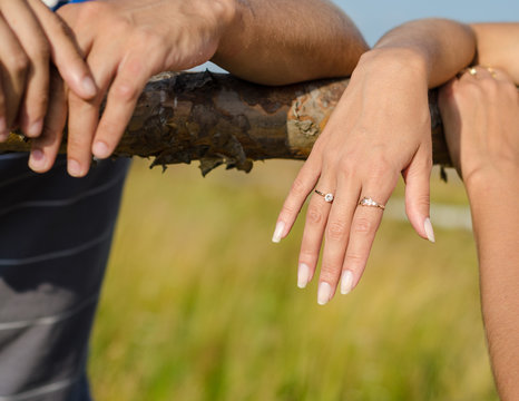 Close up photo of a hahds with wedding ring