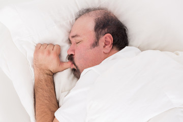 Man sucking his thumb while sleeping