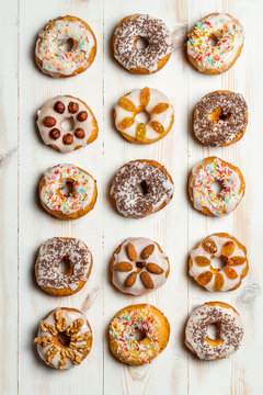 Large group of variously decorated donuts