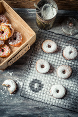 Tasting sweet donuts with icing sugar