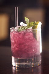 cocktail with blackberries and straw