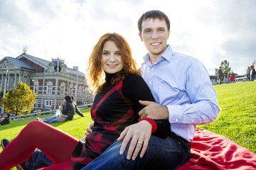 Outdoor happy couple in love, Museum Plein, autumn Amsterdam bac