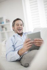 Attractive man at home using digital table