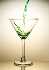 Green cocktail pouring