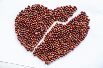 Heart of red beans on a white background