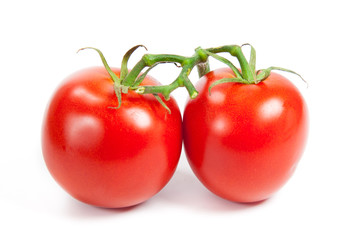 three fresh tomatoes with green leaves isolated on white backgro