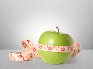 Green apples measured the meter on  white