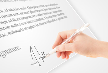 Hand writing personal signature on a paper form