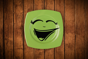 Happy smiley cartoon face on colorful dish plate