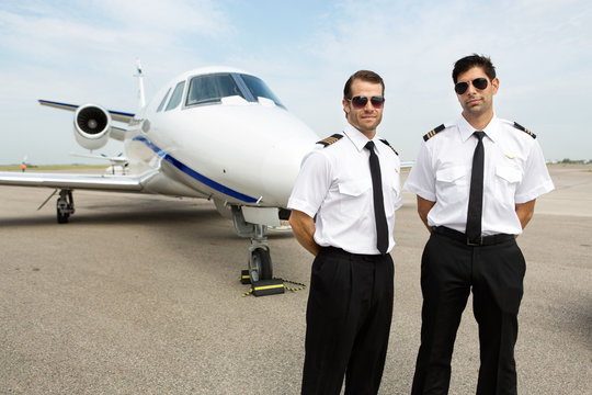 Pilots Standing In Front Of Private Jet