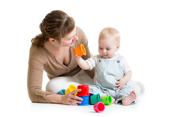 Baby boy and mother play together with cup toys