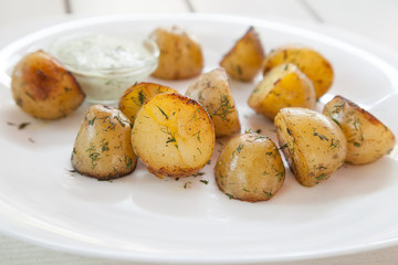 Plate with baked potatoes and dill