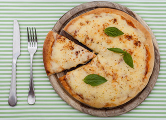 Delicious homemade pizza with ham and vegetables.
