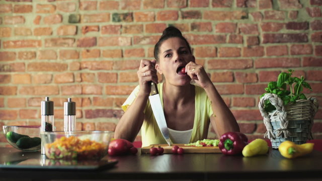 Bored woman preparing vegetable salad