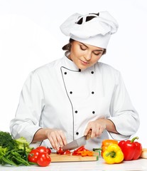 Beautiful young woman cook cutting fresh vegetables