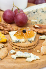 crackers with blue cheese and apple jam, nuts and grapes