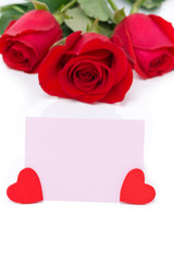 pink card for greetings, hearts and red roses