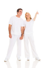 couple pointing at empty copy space