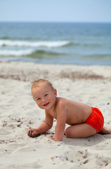 Fototapeta na wymiar cute boy having fun on beach