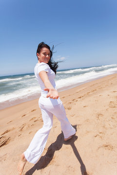 young woman running on beach