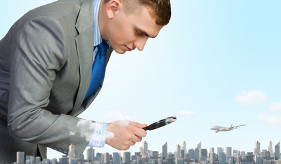 Man looking in magnifier
