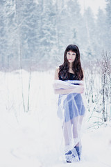 Fototapeta na wymiar Beautiful smiling woman under veil on white snow background
