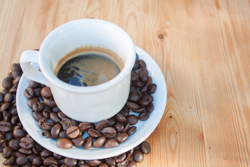 Cup of coffee with coffee beans