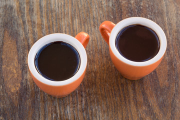 Two cups of chocolate  on a wooden table