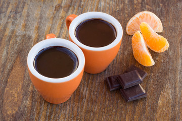 Two cups of chocolate  on a wooden table