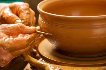 hands of a potter, creating an earthen jar