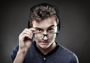Fototapeta na wymiar Handsome teenager wearing trendy cap and glasses