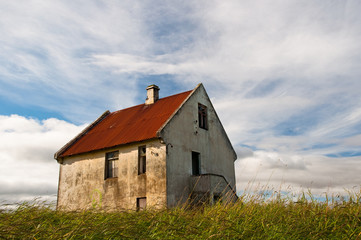 Fototapeta na wymiar Abandoned house with rusty roof
